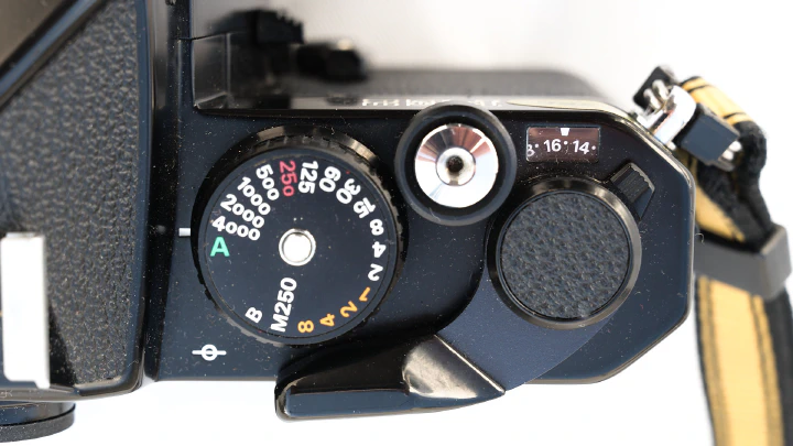 A photo of the RHS of the Nikon FE2 top-plate with shutter speed dial, shutter release, film counter and film advance lever