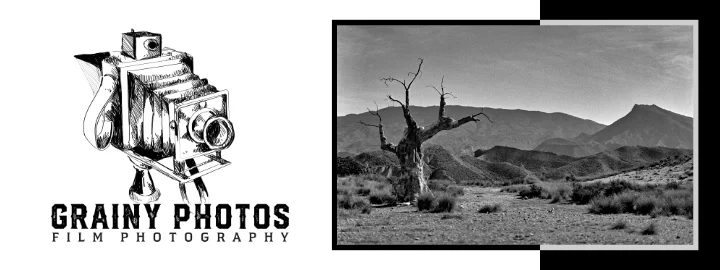 Website banner comprising an old large format film camera pencil drawing of the left with the text: GRAINY PHOTOS, FILM PHOTOGRAPHY. A black-and-white photo on the right shows an arid landscape with a large dessicated tree in the left foreground with rolling hills in the mid and background.