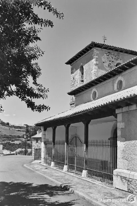 A black-and-white film photo of the San Justo y Pastor church in Alba de los Cardaños