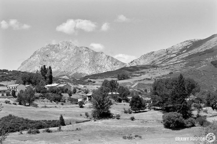 A black-and-white film photo of the Barrio Castro, Alba de los Cardaños