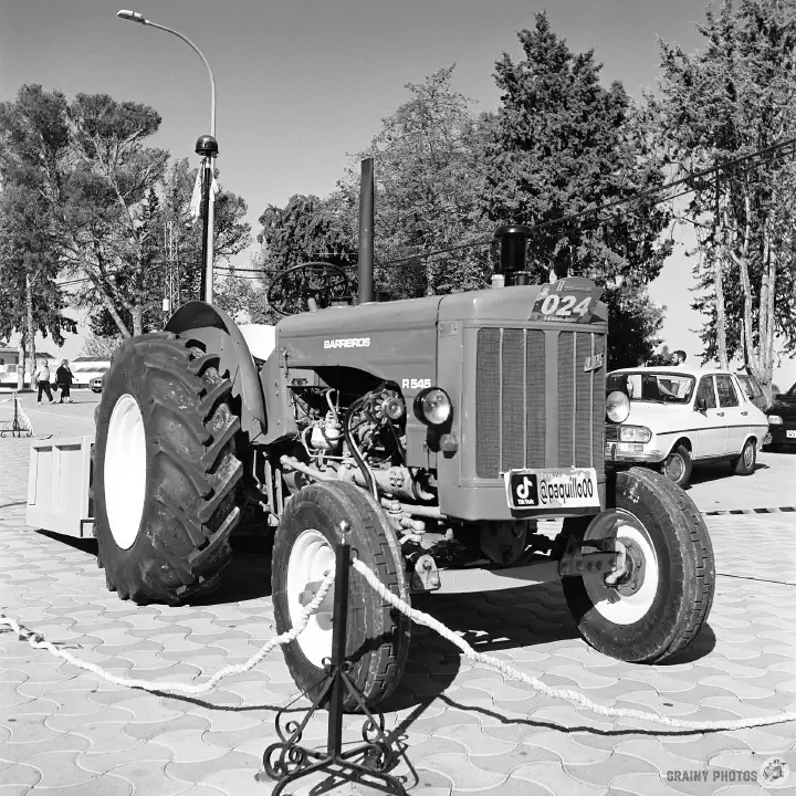 Black-and-white film photo of a tractor