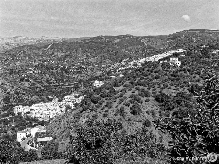 A black-and-white film photo of the nearby villages of Árchez and Canillas de Albaida