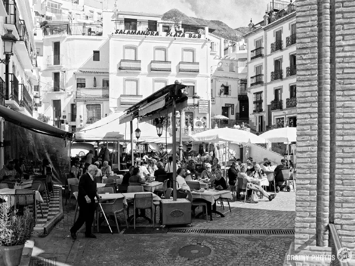 A black-and-white film photo of restaurants and bars in the Plaza de la Almijara