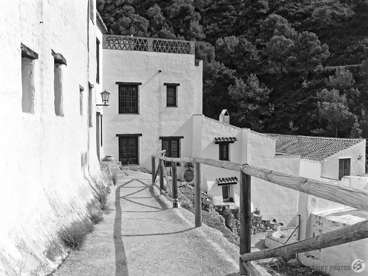 A black-and-white film photo of white houses in El Acebuchal