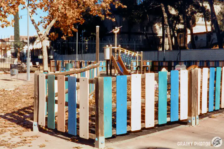 A colour film photo of a children's play area in a park. Shot on Harman Phoenix 200 film.