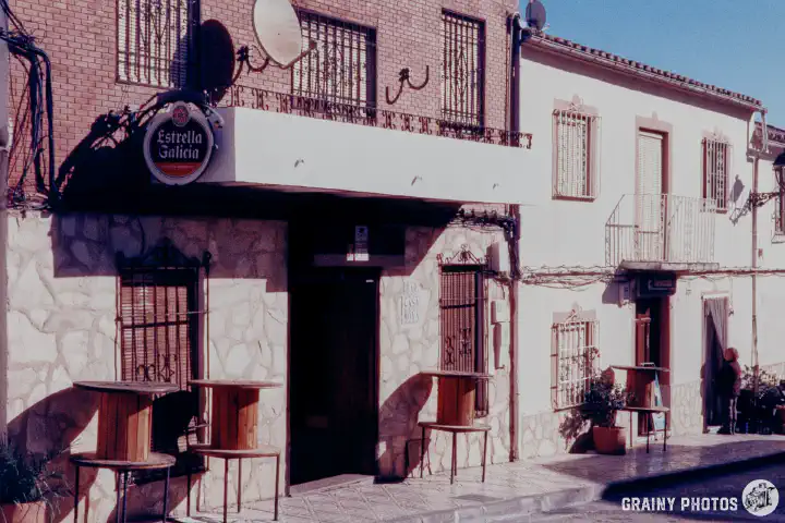 A colour film photo of a Spanish village bar in a side street. Shot on Harman Phoenix 200 film.