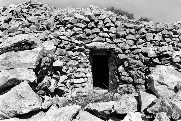 A black-and-white photo of an entrance to a Caracole