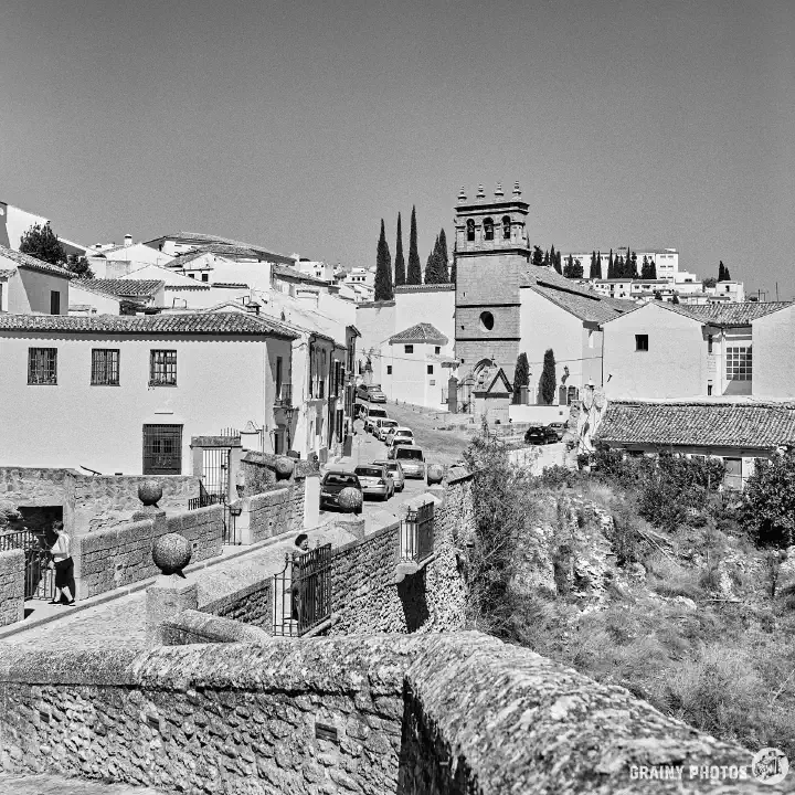 A black-and-white film photo of the newer part of the city viewed from the Arco de Felipe V.