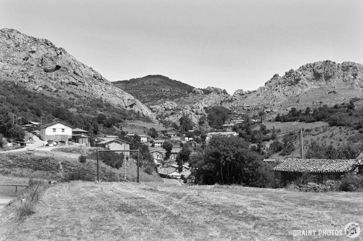 A black-and-white film photo of Santibáñez de Resoba nestling in a valley