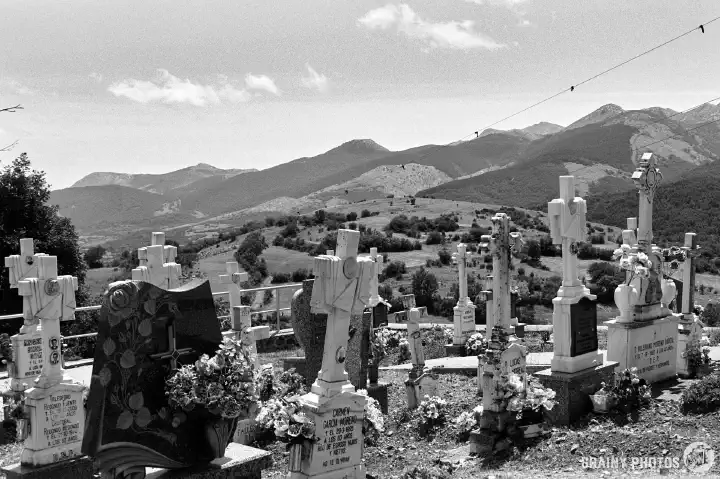 A black-and-white film photo of the Cementery next to Iglesia de San Cristóbal, Santibáñez de Resoba