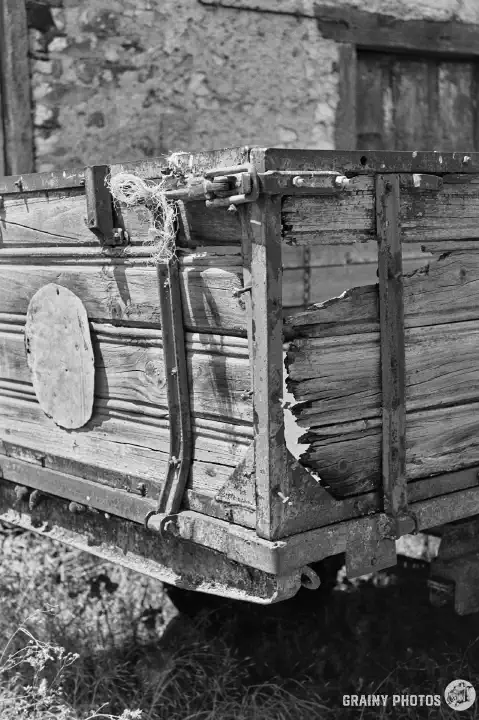 A black-and-white film photo a close-up of the trailer showing decay