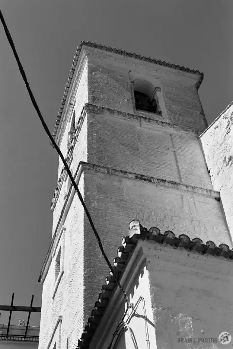 A black-and-white photo of the belfry of the Santa María La Mayor church