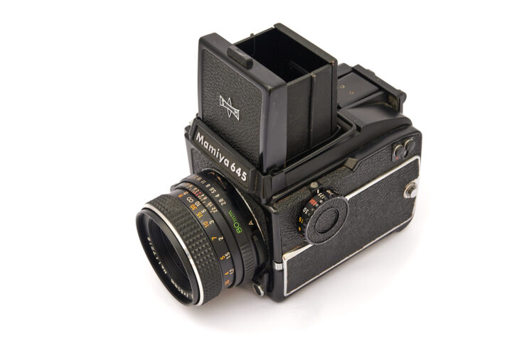 A close-up view of a Mamiya 645S medium format camera featuring a detachable film holder, a wide lens, and a classic black design, showcasing its details and craftsmanship suitable for photography enthusiasts.