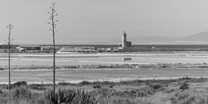 Black and white photo of Las Salinas salt flats with the prominent San Miguel church